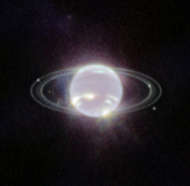 An image of Neptune from within space, taken by NASA. It looks like it is glowing with a white light on the planet, while the rings around it are clearly visible around it.